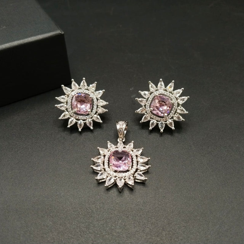 Jewelry set with pink gemstones and silver accents on a dark background